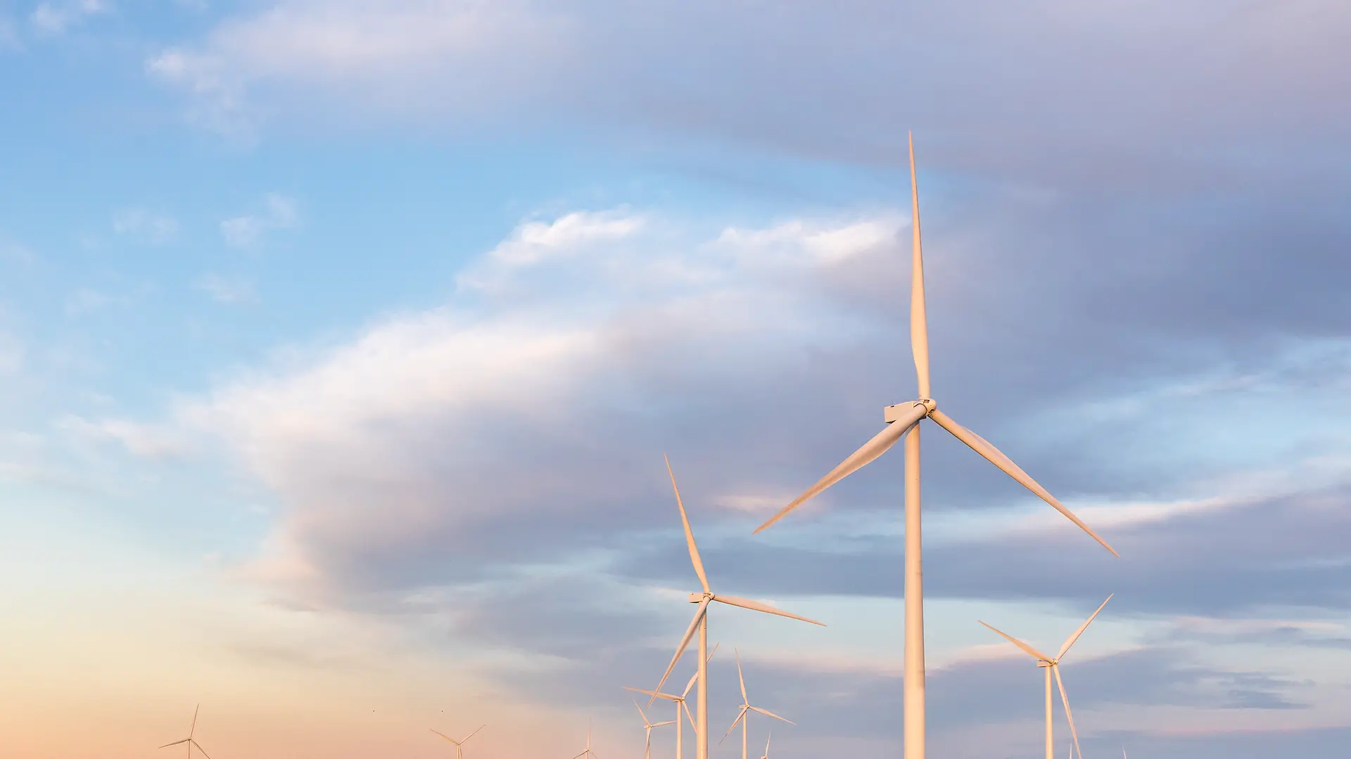 Wind turbines of a wind farm with sky in the background