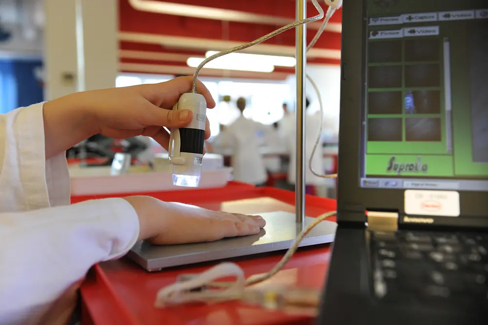 A boy experiments on a digital microscope