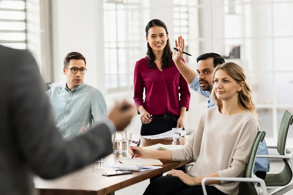 Culture of collaboration: Five colleagues are engaged in a vivid and interactive discussion.