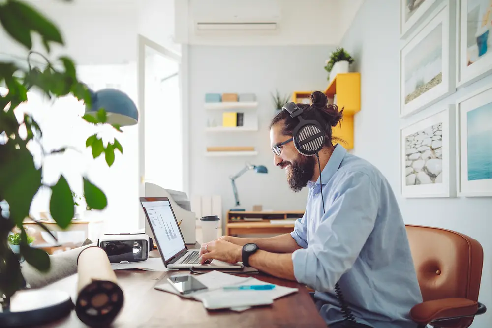 Man with headset sitting at desk working 