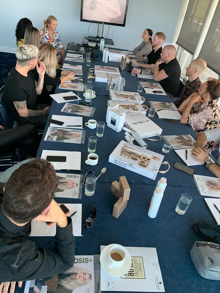 Members of the SKP Collective sitting around a table discussing the entries